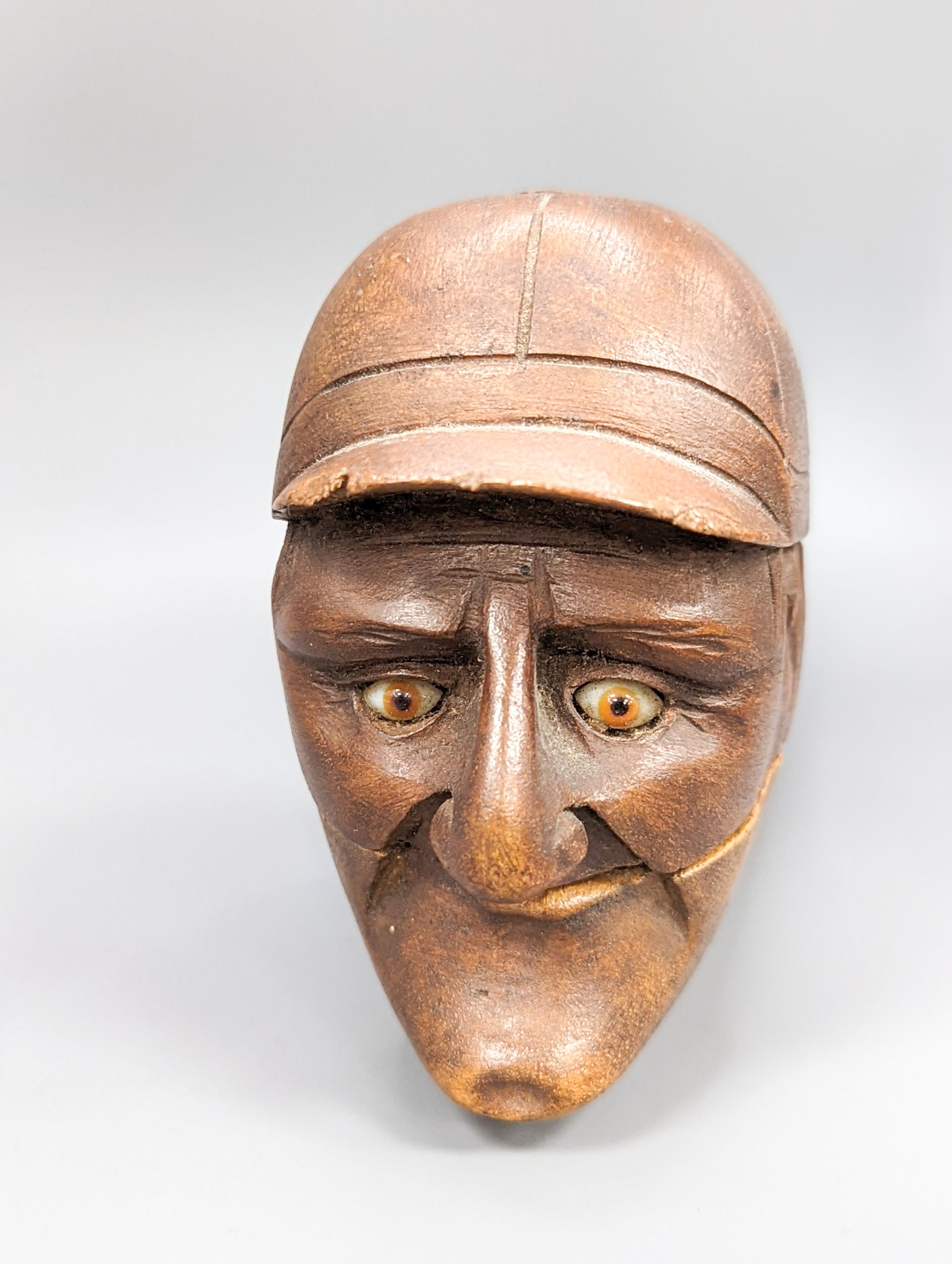 A pair of Victorian treen nutcrackers, in the form of a jockey’s head, glass in set eyes, length 20cm